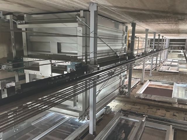Elevator shaft interior showing guide rails and mechanical components