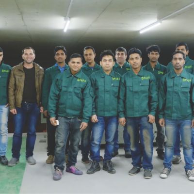 Elevator installation team in factory uniforms posing together