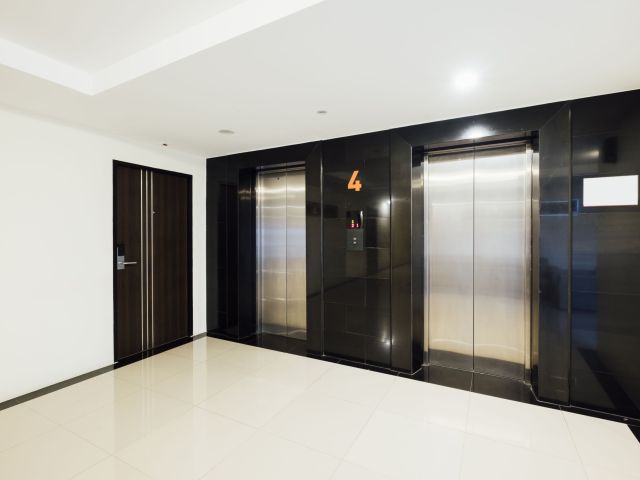 Sleek modern elevator entrance in a commercial building lobby