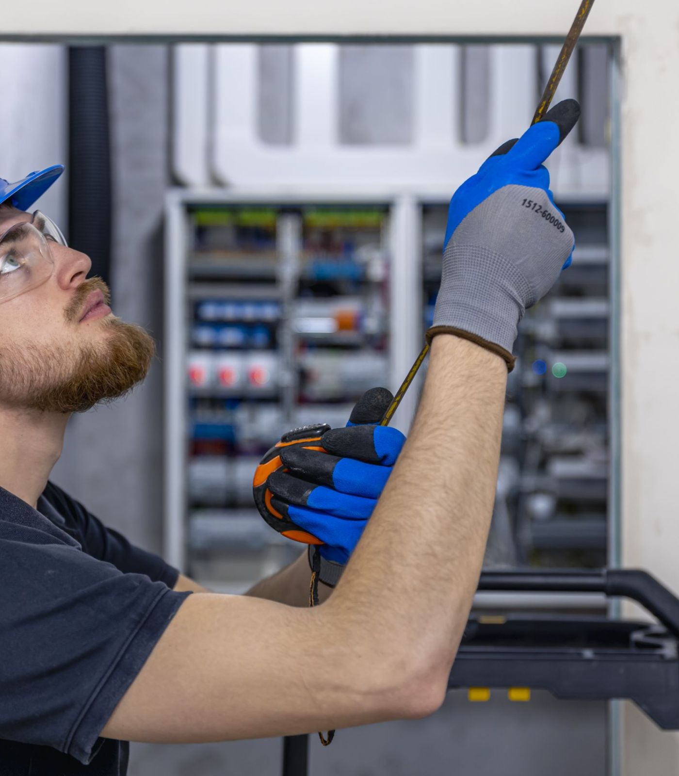 Electrician installing laying electrical cables on elevator
