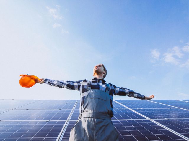 man worker firld by solar panels scaled