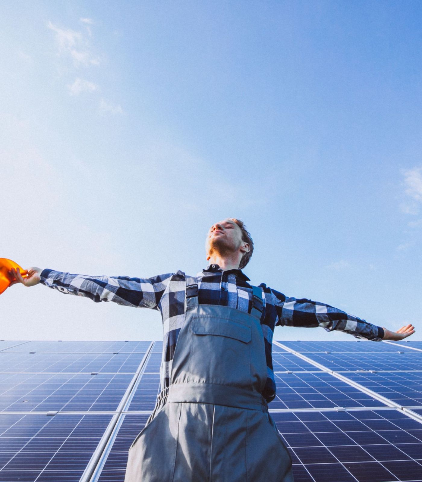 man worker firld by solar panels scaled