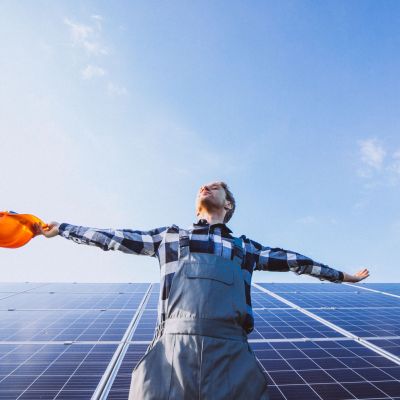 man worker firld by solar panels scaled