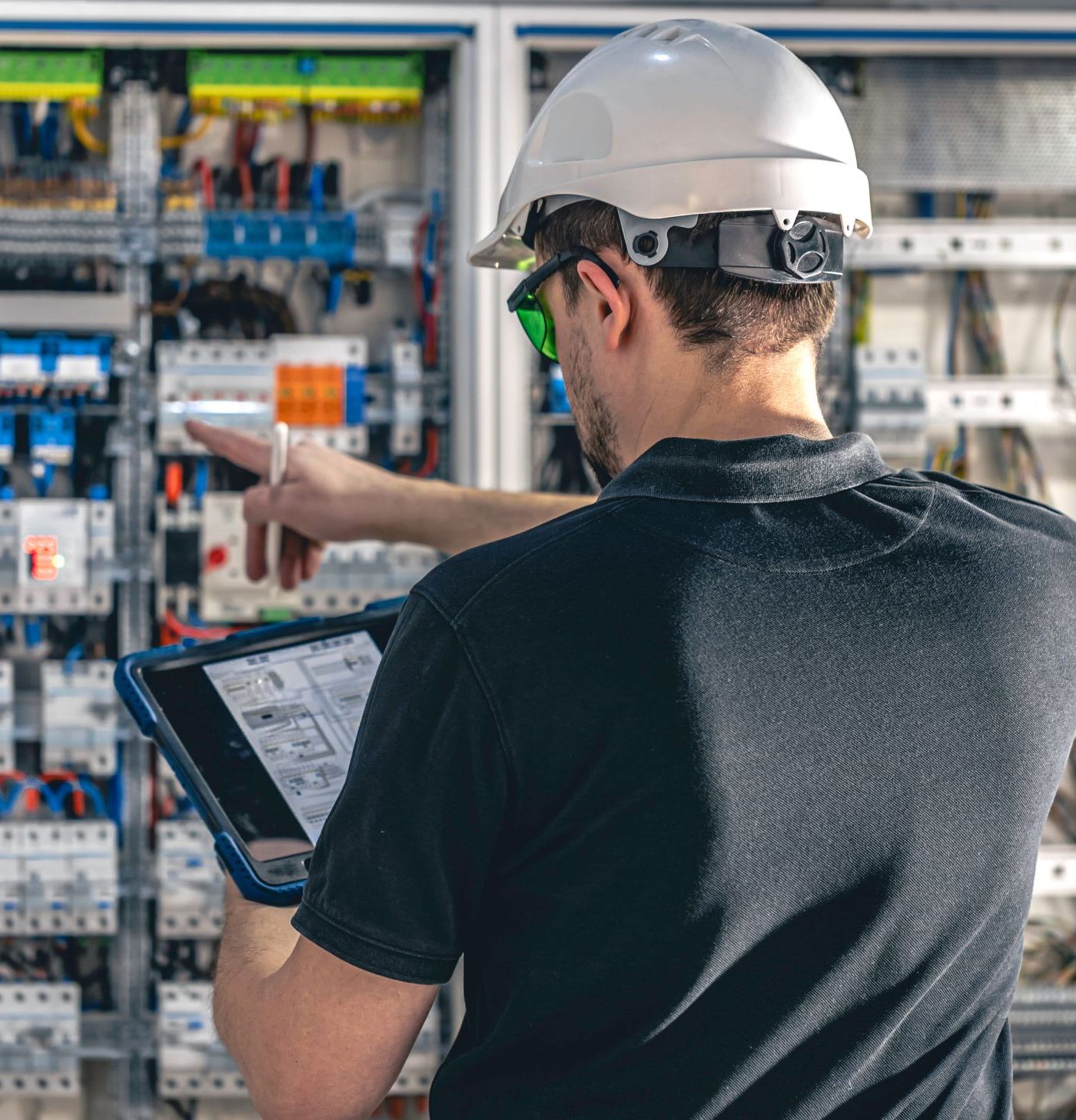 man electrical working switchboard with fuses for elevator