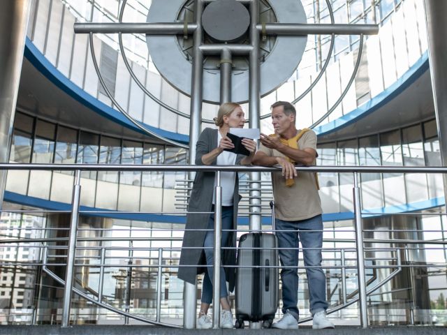 focused middle aged man and woman having a discussion over the lift industry